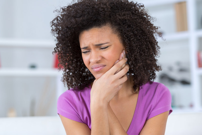 Nice lady holding her jaw in pain because of tmj
