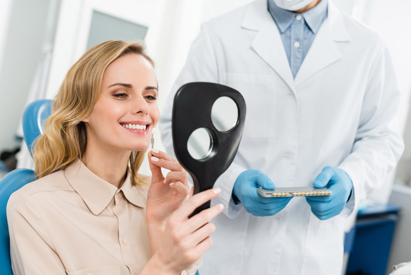 Nice lady looking at her new cosmetic make over in the mirror