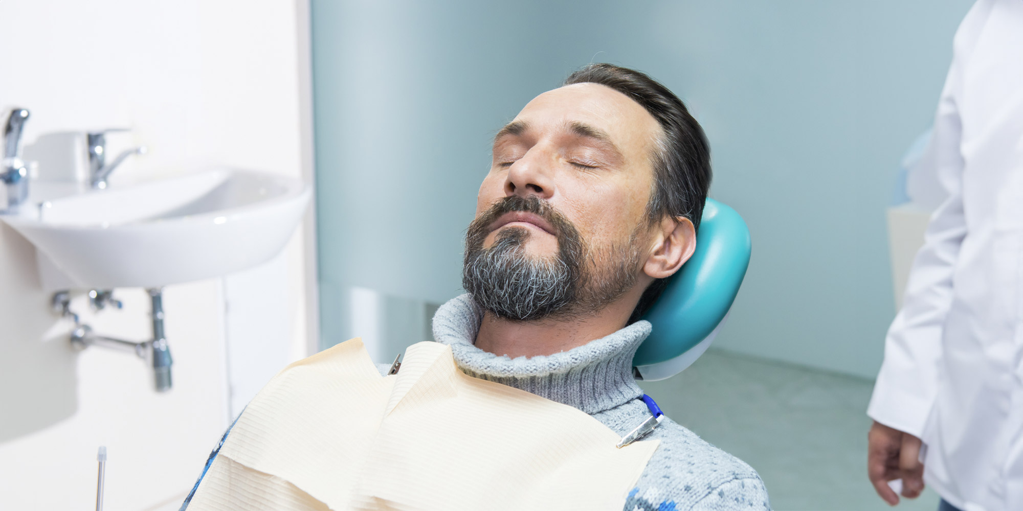 Guy sound asleep in dental chair thanks to sedation