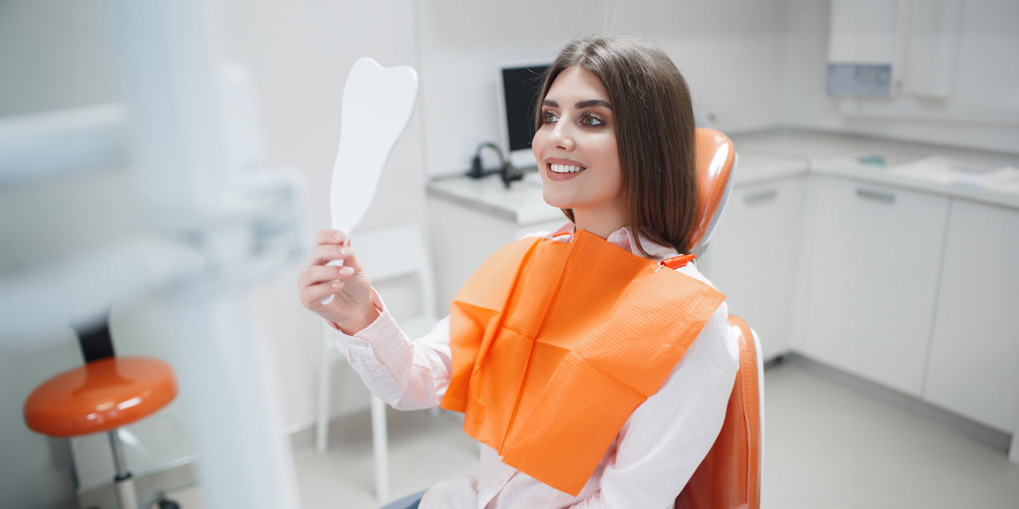 Nice lady looking at her new cosmetic make over in the mirror