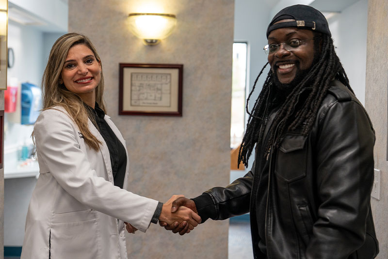 patient and doctor shaking hands after patient treatment
