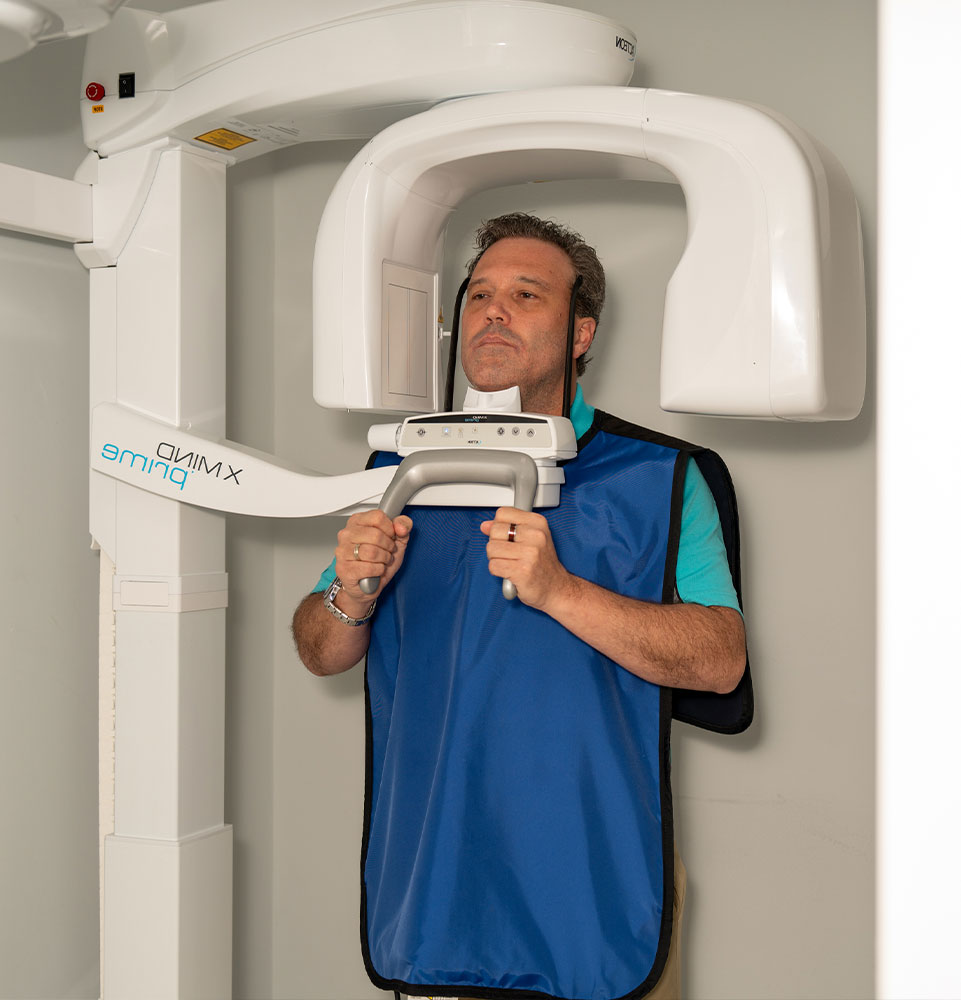 patient undergoing scan for dental procedure within the dental center