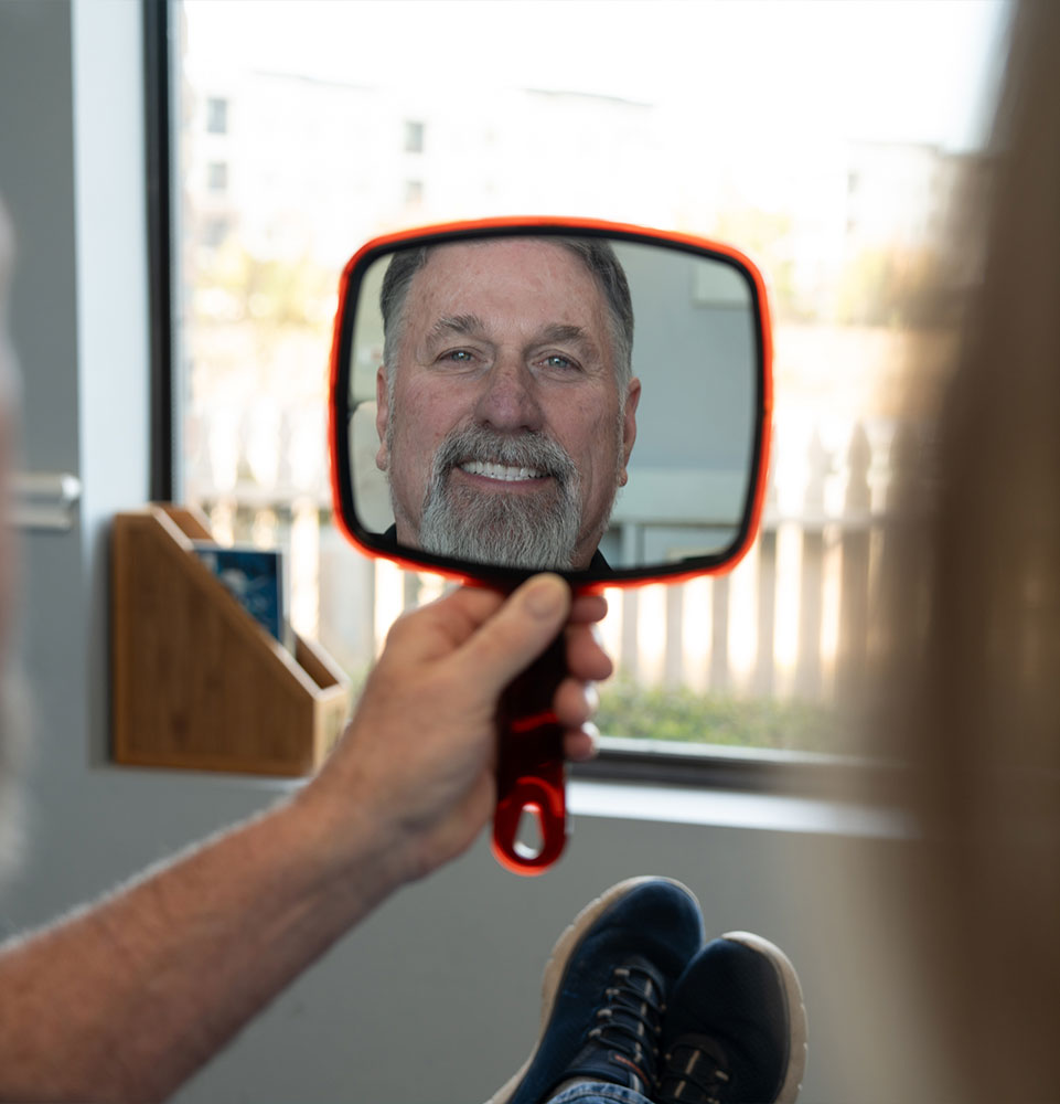 patient smiling brightly after their dental treatment within the dental center