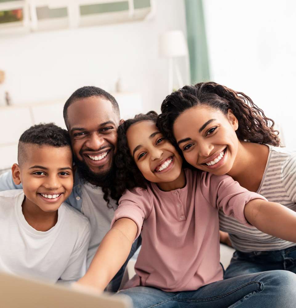 Family photo in the living room happy because they go to Dental Care and Implants