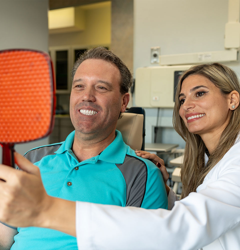 patient and doctor smiling brightly after patient procedure