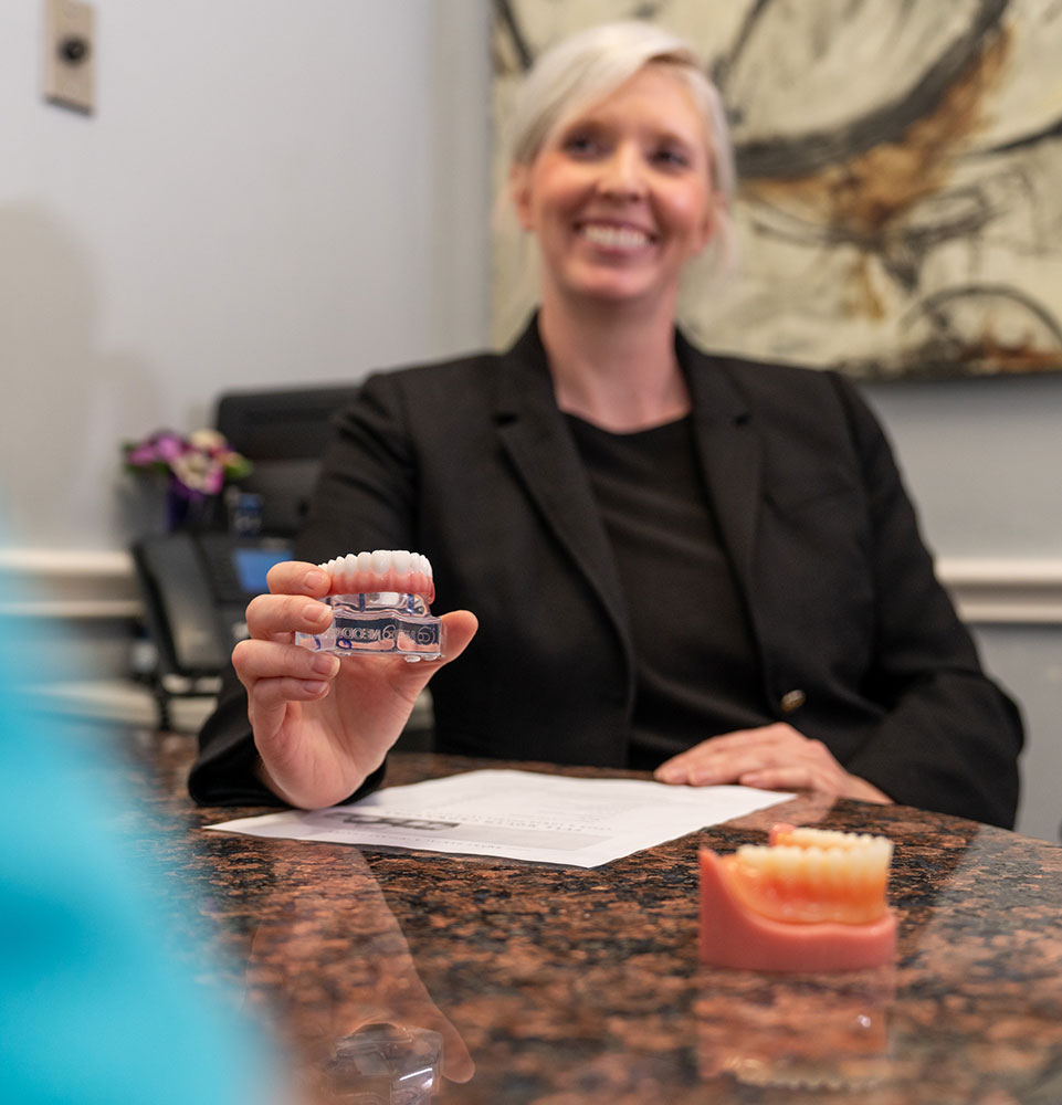 staff member showing implant model and options