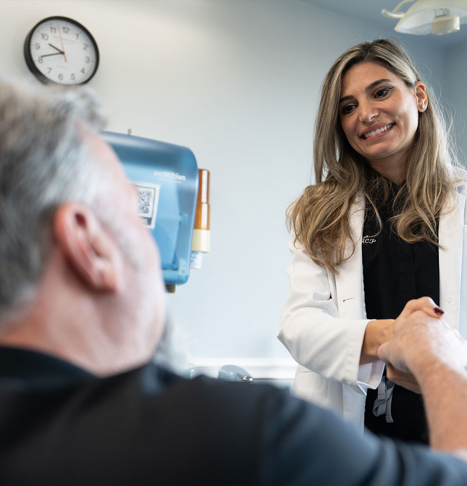 doctor shaking hands with patient within the dental center