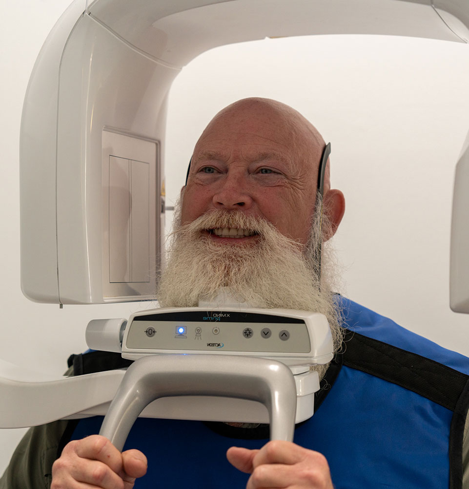 patient undergoing scan for dental procedure within the dental center