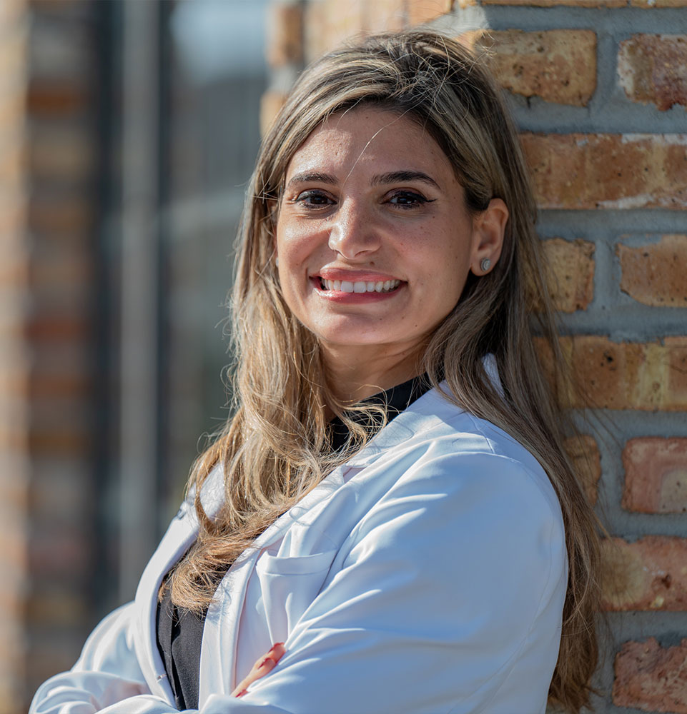 headshot of doctor smiling outside of the dental center