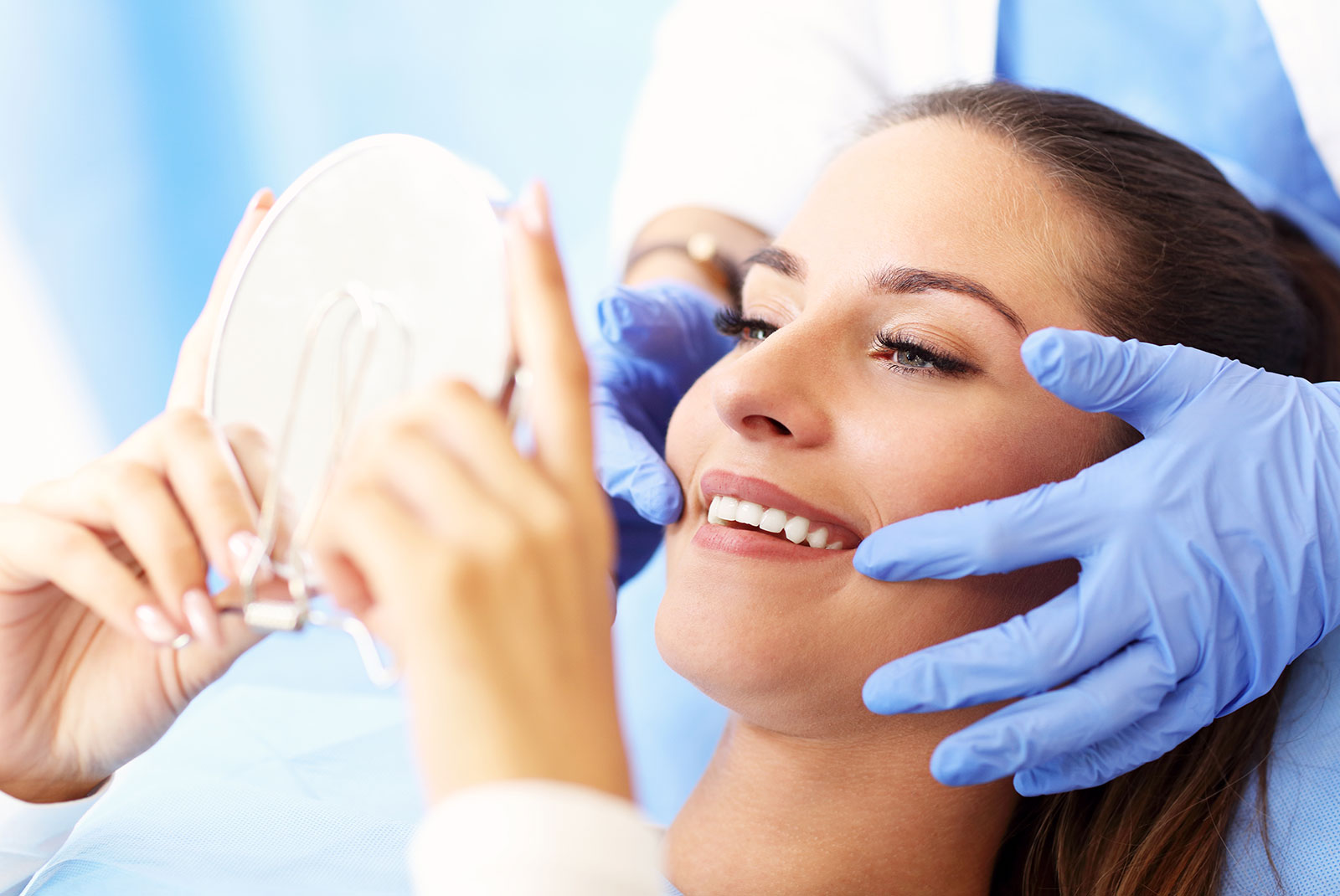 patient smiling brightly after their dental treatment within the dental center