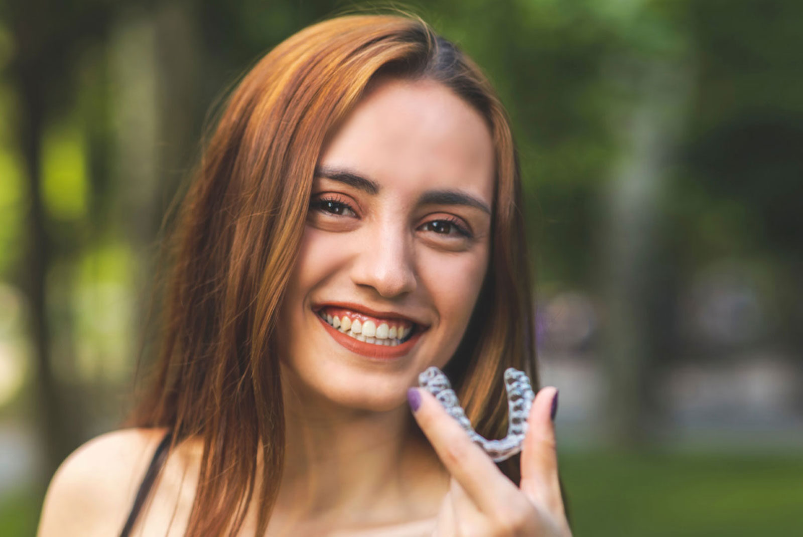 invisalign patient new smile holding